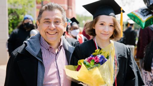 father and daughter posing at graduation