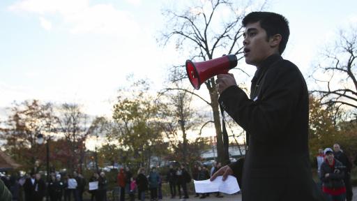 A student holding a megaphone at a protest rally.