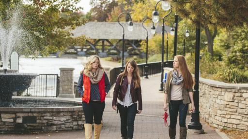 students walking along the riverwalk in downtown naperville