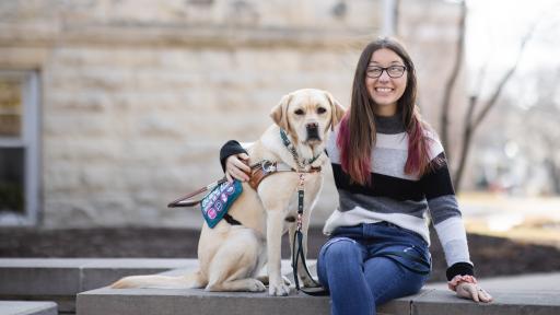 student posing with service dog