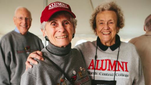 alumni in tailgate tent