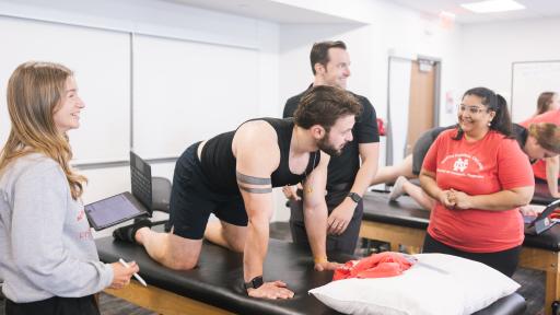 A photo of DPT students working on a lab in a classroom on campus.