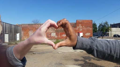 Two hands forming the shape of a heart.