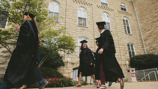 students in car and gown before graduation